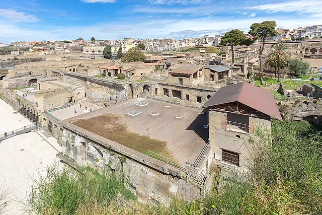 Excavations of Herculaneum seen from above with the modern town of Ercolano behind