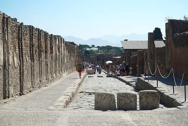 The paved Via dell'Abbondanza in Pompeii with stepping stones across the roadway