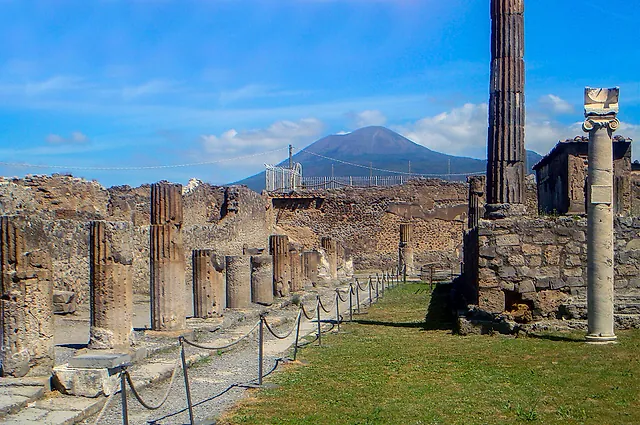 The columns of the Temple of Apollo in Pompeii with Mount Vesuvius on the horizon