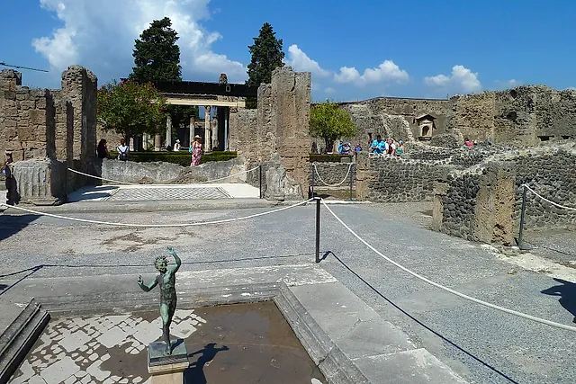 The atrium of the House of the Faun in Pompeii with a copy of the dancing faun statue on the impluvium